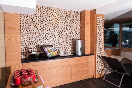 a kitchen with a wall with a patterned wall at Hotel Cristiania in Madonna di Campiglio
