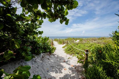 a path leading to the beach with a fence at Serenity in Captiva