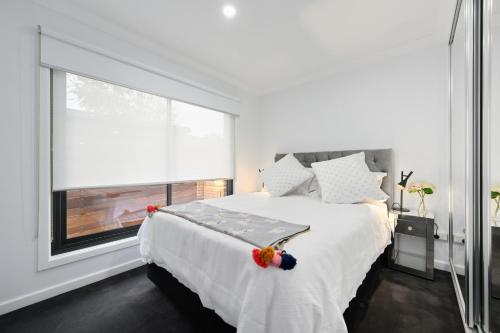a bedroom with a bed and a large window at Comfort & Style - Luxurious Central Apartment in Albury