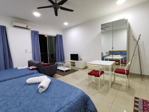 a bedroom with a blue bed and a living room at G-mat Staycation free WiFi & Netflix in Cyberjaya