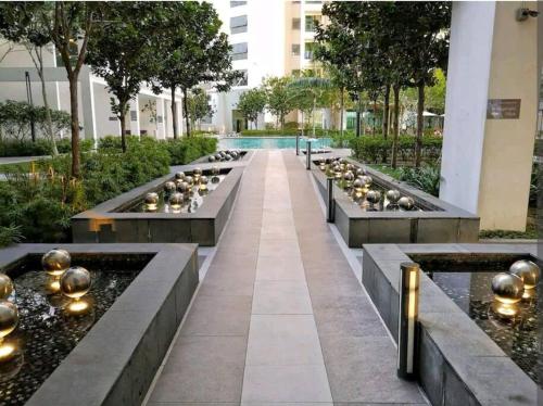 a long walkway with three benches and a pool at G-mat Staycation free WiFi & Netflix in Cyberjaya