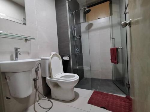 a bathroom with a shower and a toilet and a sink at G-mat Staycation free WiFi & Netflix in Cyberjaya