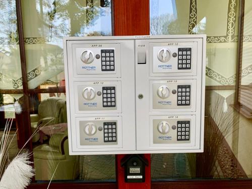 a white control box in front of a window at KrabatResidenz - Apartmenthaus in Burg