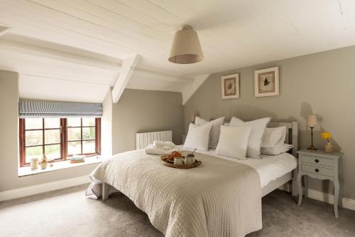 a bedroom with a bed with a bowl on it at Swallow Cottage in Port Isaac