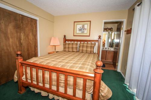 a bedroom with a wooden bed in a room at Boulder Creek -1417 by Big Bear Vacations in Big Bear Lake