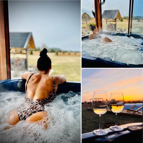 a woman in a hot tub with a glass of wine at Willa na Mazurach ze SPA, Basenem i Jacuzzi in Giże