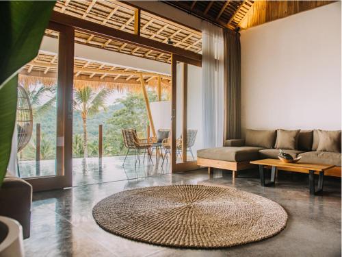 a living room with a couch and a table at Neano Escape in Candidasa