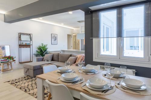 a dining room and living room with a table and chairs at Espectacular El Pilar8 By VigoVacaciones in Vigo