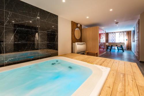 a bathroom with a large tub in a room at Chalet Izoard in Saint-Chaffrey