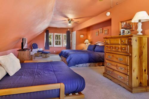 a bedroom with two beds and a dresser at Jus' Restin-265 by Big Bear Vacations in Big Bear Lake