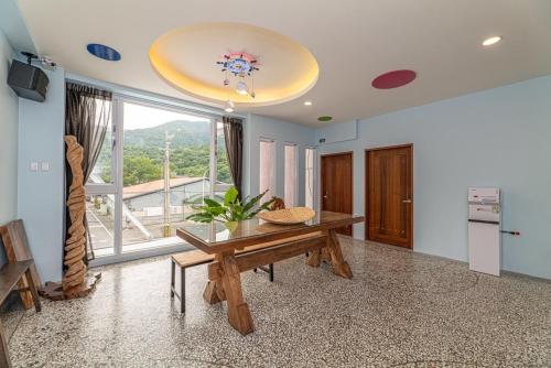 a living room with a table and a large window at 睡海邊包棟民宿 sleep on beach B&B in Suao