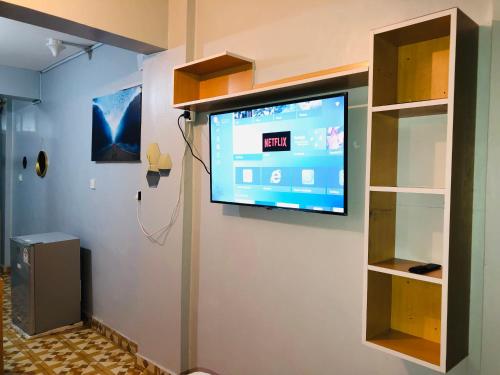 a flat screen tv hanging on a wall at Loaded homes in Kikuyu