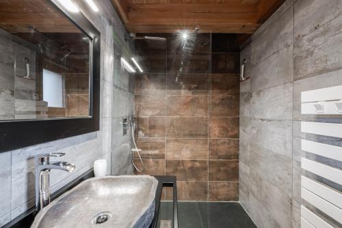 a bathroom with a sink and a mirror at Chalet Galibier in Saint-Chaffrey