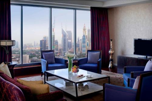a living room with a view of a city at The H Dubai in Dubai