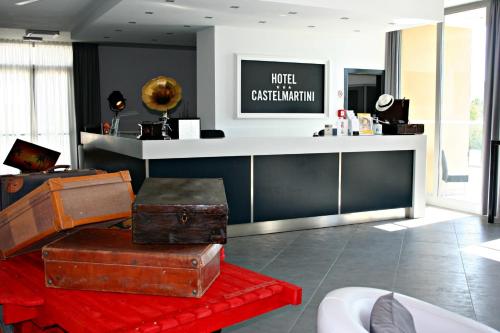 a lobby with a pile of luggage on a red rug at Castelmartini Wellness & Business Hotel in Larciano