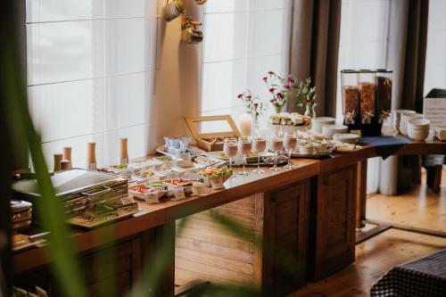 a long table with dishes of food on it at Hotel nad Wisłą in Tczew