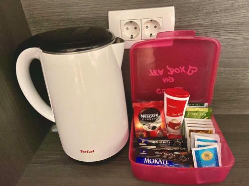 a white coffee pot and a box with some items at Apartma Mija-Dekani in Dekani