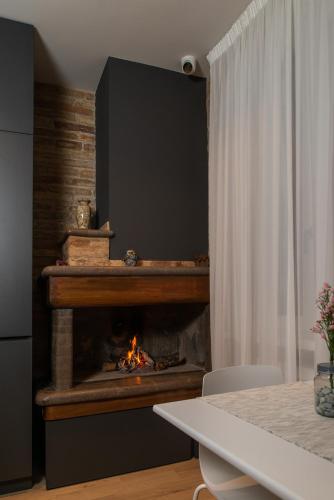 a fireplace in a living room with a fire in it at Civitaloft Luxury Rooms in Civitanova Marche