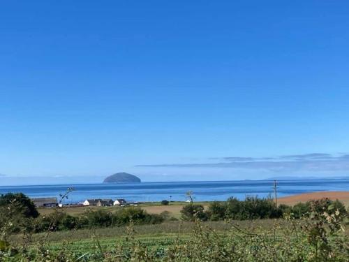 a view of the ocean from a field at Carnoustie 24 - Turnberry Holiday Park - short walk to beach in Girvan