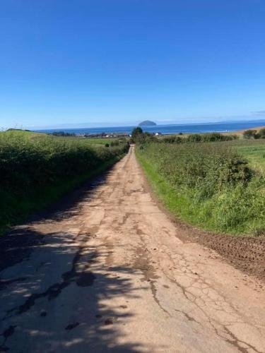 a dirt road in the middle of a field at Carnoustie 24 - Turnberry Holiday Park - short walk to beach in Girvan