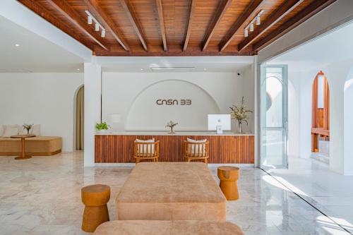 a lobby with a table and chairs and a counter at Casa 33 Hatyai in Hat Yai