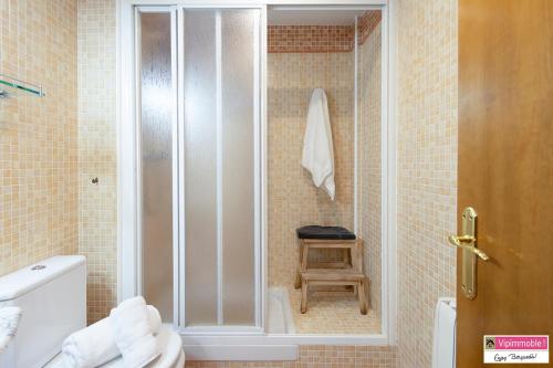 a bathroom with a shower with a toilet and a stool at Apartament Tritó - Rústico y acogedor con vistas - 2p in Guardiola de Berguedà
