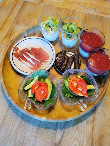 a table topped with plates of food on a table at Rikke og Franks Svineri in Lemvig