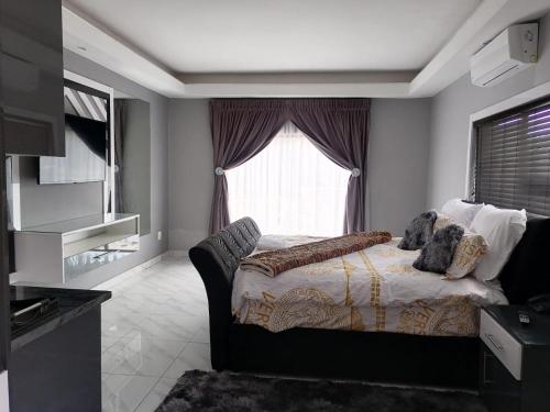 a bedroom with a bed in front of a window at National Lodge in Benoni