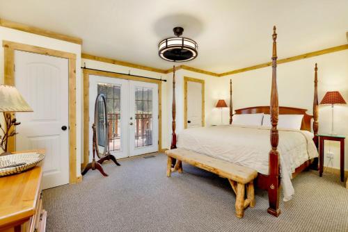 a bedroom with a bed and a bench at Happy Bear #2053 by Big Bear Vacations in Big Bear Lake
