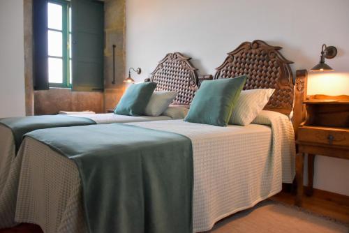 En eller flere senge i et værelse på Casa do Torno
