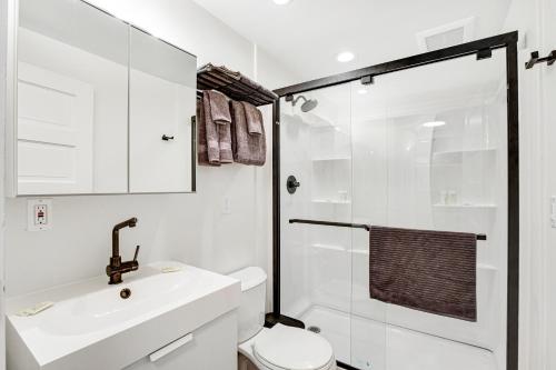 a bathroom with a toilet and a sink and a shower at Ballard Bliss Studio in Seattle