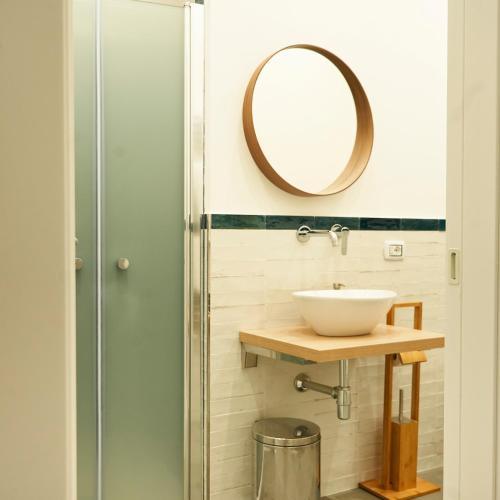 a bathroom with a sink and a mirror at Ballarò Guest House in Palermo