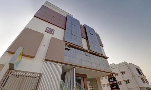 a building with glass windows on the side of it at Treebo RJ Residency in Mysore
