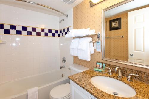 a bathroom with a sink and a toilet and a mirror at SOUTH SEAS GULF BEACH VILLA 2026 in Captiva