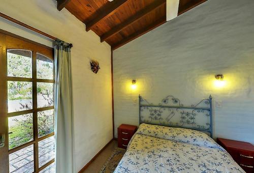 Ένα ή περισσότερα κρεβάτια σε δωμάτιο στο Hosteria Rural Piedra y Camino