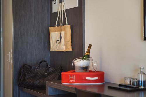 a bottle of champagne on a table with a wine glass at Hi Hotels Trento - Wellness & Spa Adults Only in Trento