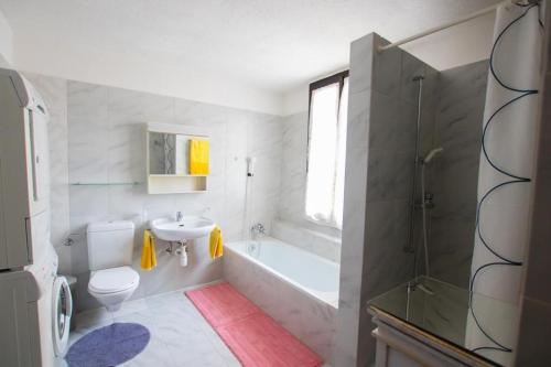 een badkamer met een bad, een wastafel en een toilet bij CARMEN HOME in Grancia