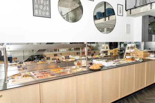 a buffet line with a lot of food at Loop Hotel Vilnius in Vilnius