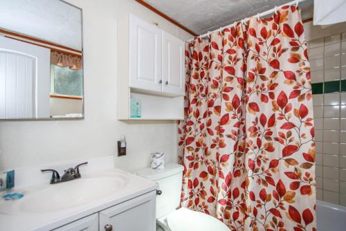 a bathroom with a sink and a shower curtain at Palms To Pines-1877 by Big Bear Vacations in Sugarloaf