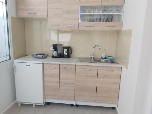 a small kitchen with a sink and a refrigerator at Antonios 1 in Matala