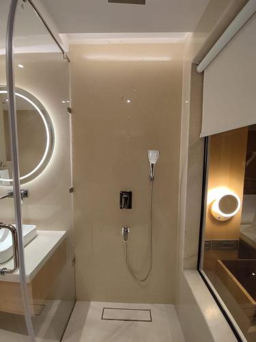 a bathroom with a shower and a sink at Damson Plum in Lucknow