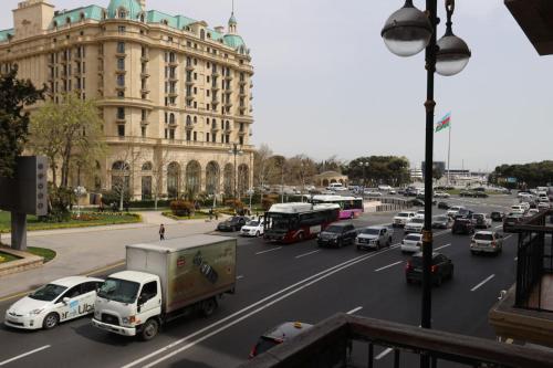 a busy city street with traffic in front of a building at Azneft Royal Suite Apartment Sea View in Baku