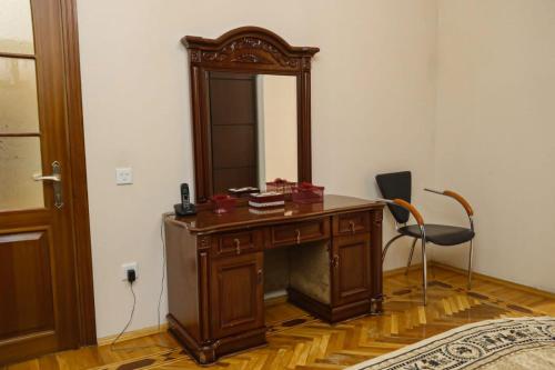 a desk with a mirror and a chair in a room at Azneft Royal Suite Apartment Sea View in Baku