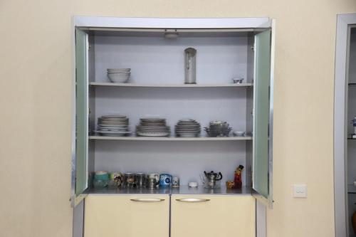 a cabinet with plates and dishes in it at Azneft Royal Suite Apartment Sea View in Baku