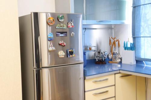 a kitchen with a stainless steel refrigerator with magnets at Azneft Royal Suite Apartment Sea View in Baku
