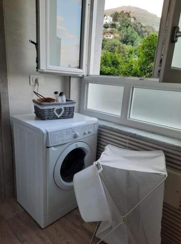 a laundry room with a washing machine and a window at Marolù Casa Vacanze in Vietri sul Mare