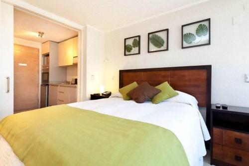 a hotel room with a bed and two lamps at Departamentos Costa Nueva de Lyon in Santiago
