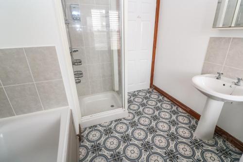 a bathroom with a shower and a sink at 15 Tower Meadows in Penzance