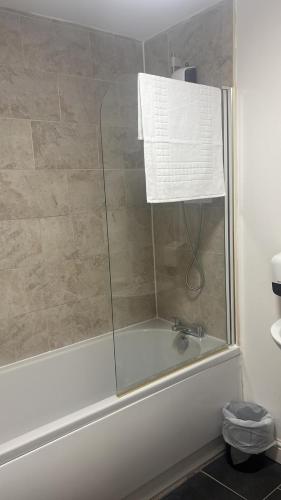 a shower with a glass door and a sink at Park View in Hull