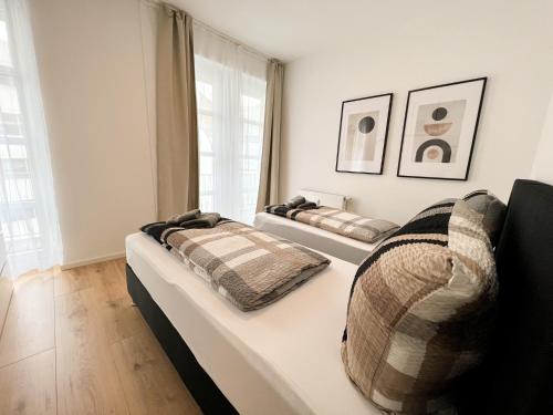 a bedroom with two beds and a window at Centerapartments Premium DeLuxe in Düsseldorf